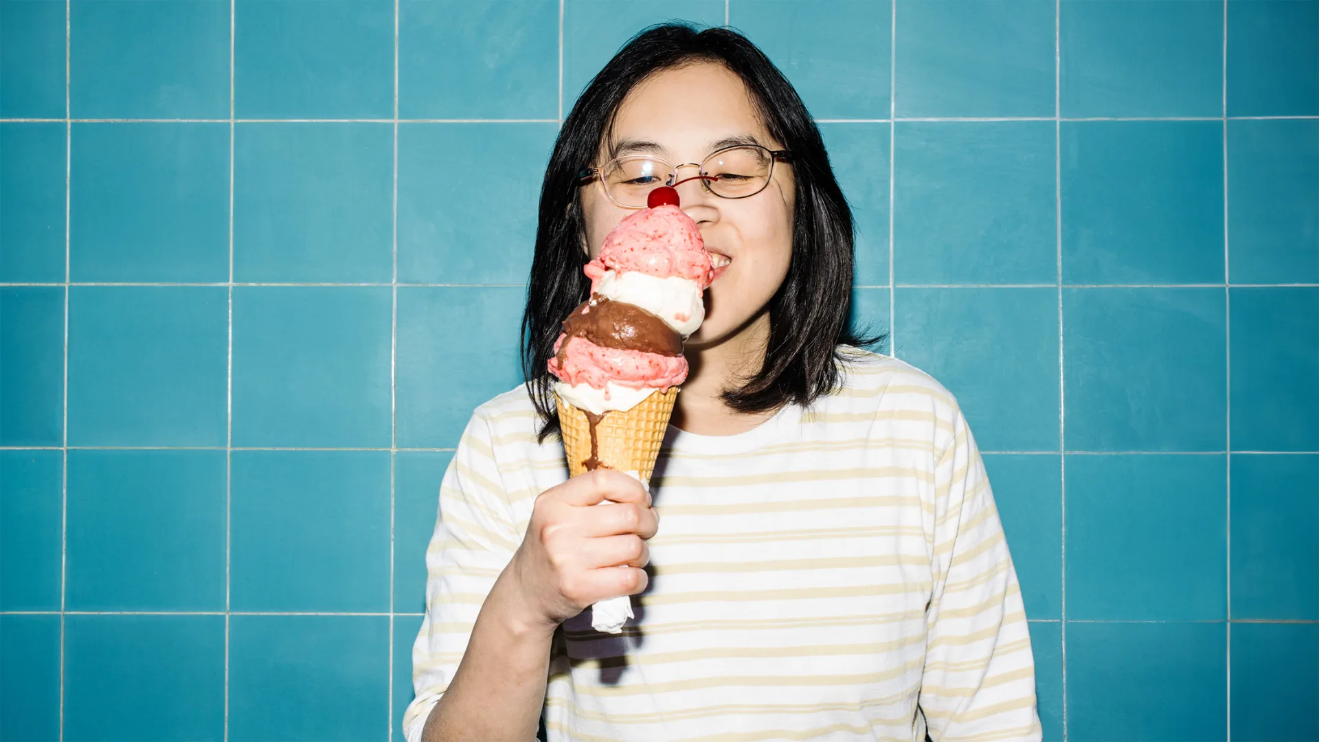 Journalist Lee Tran Lam of the Culinary Archive podcast holds a stacked ice cream cone.