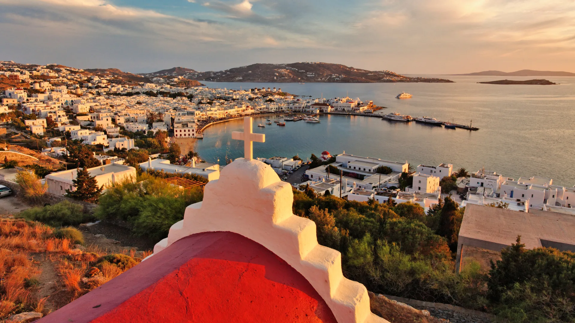 Elevated view of Mykonos Harbor at sunset.