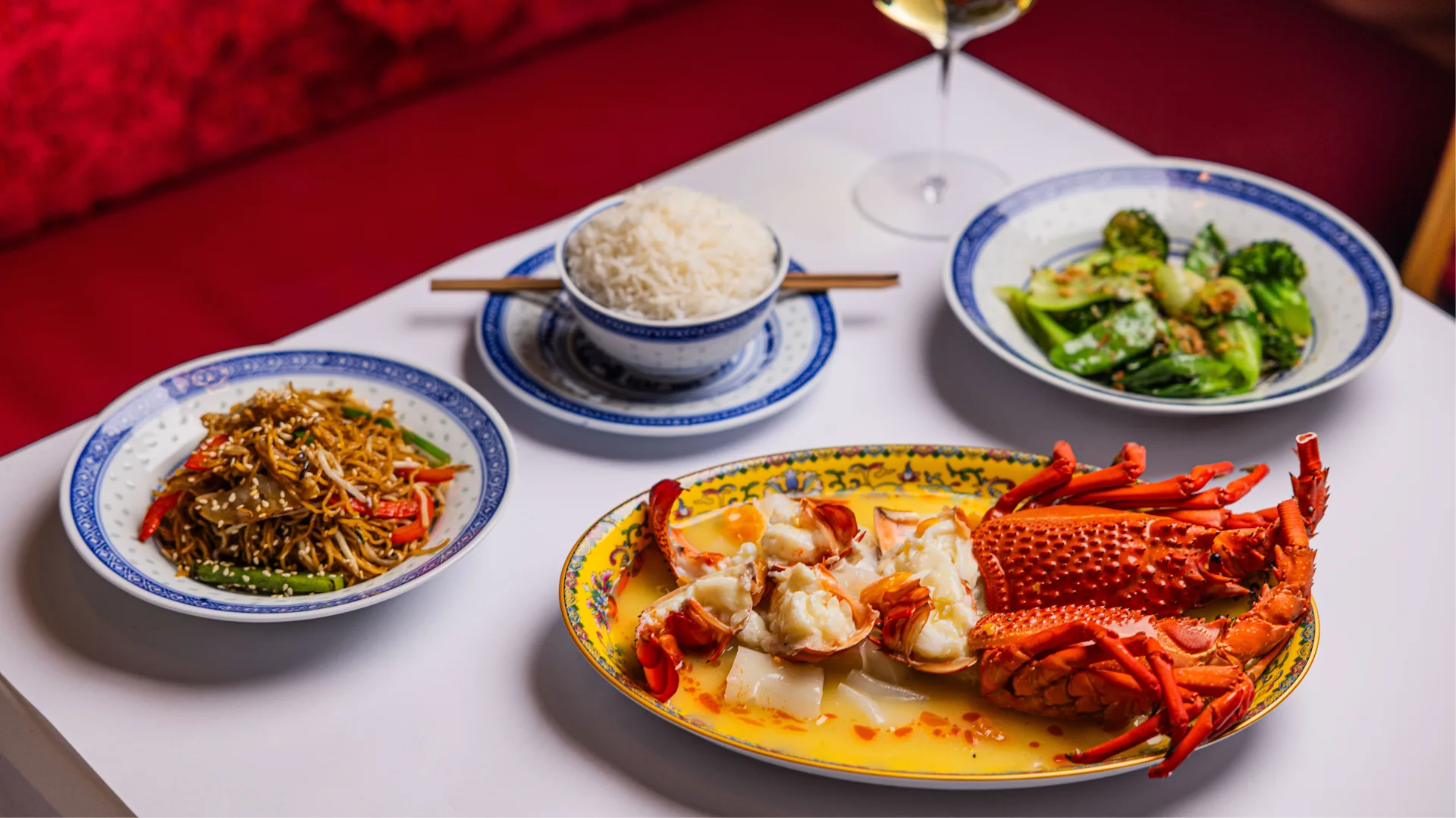 A spread of Chinese dishes including lobster chow mein, fried noodles and rice at Young's Palace in Potts Point.