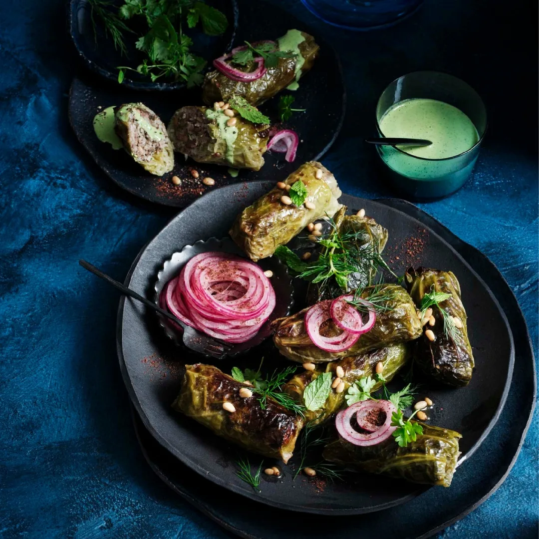 Spiced lamb and rice stuffed cabbage rolls with green tahini sauce