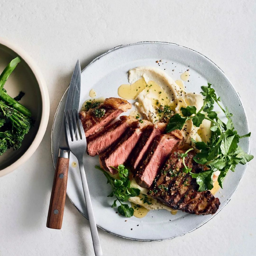 Char-grilled sirloin steaks with anchovy butter and swede purée