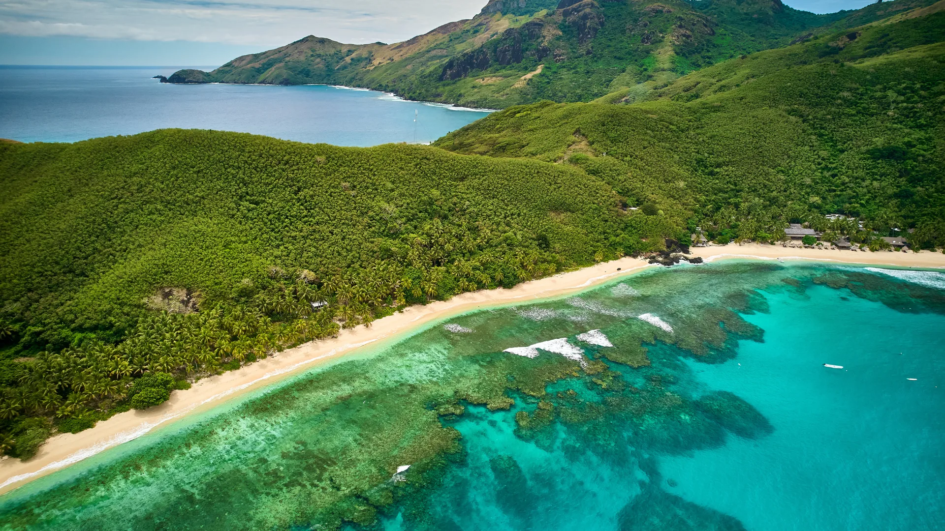 High view of coral reef and mountains on Waya Island in the Yasawa Islands, a volcanic archipeligo located northwest of the Fiji mainland