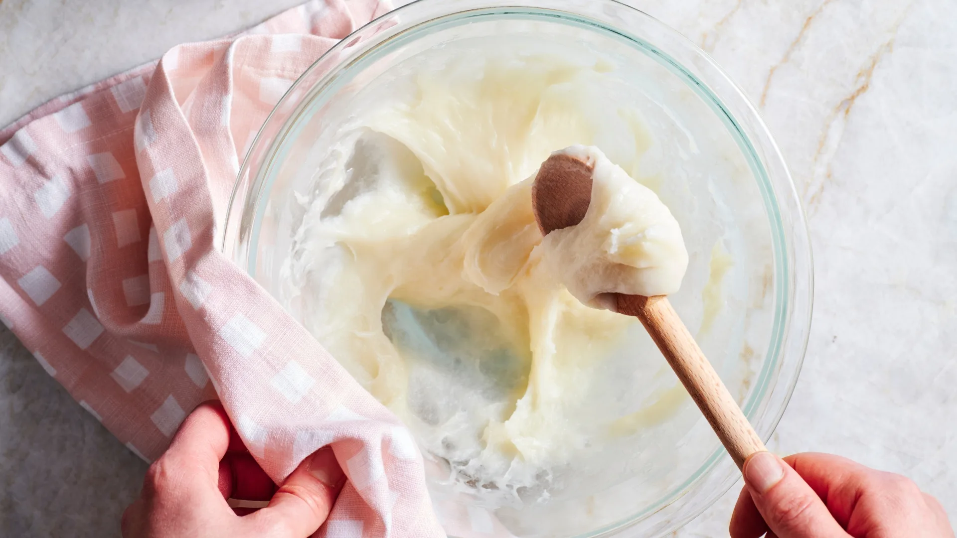Mochi dough around a wooden spoon.