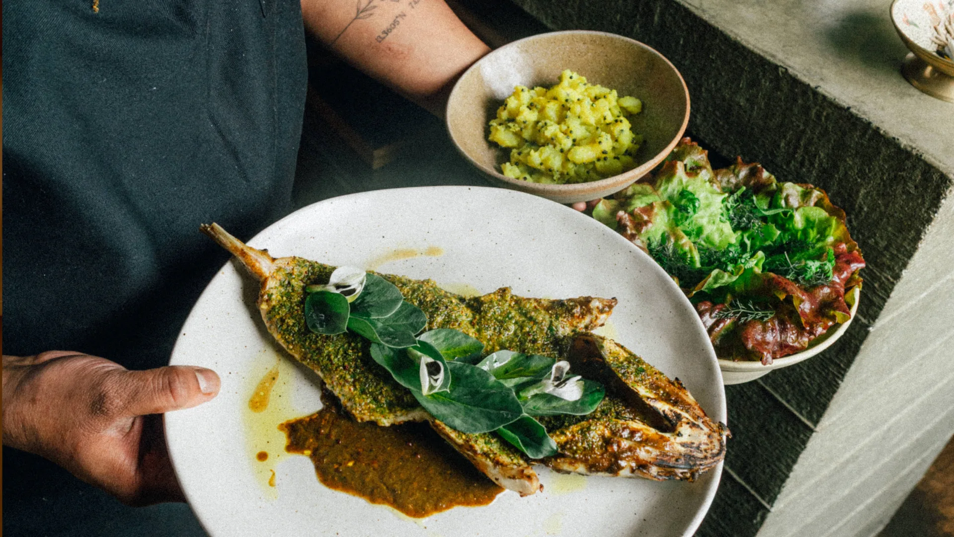 A grilled fish and side dishes at Melbourne modern Indian restaurant Saadi.