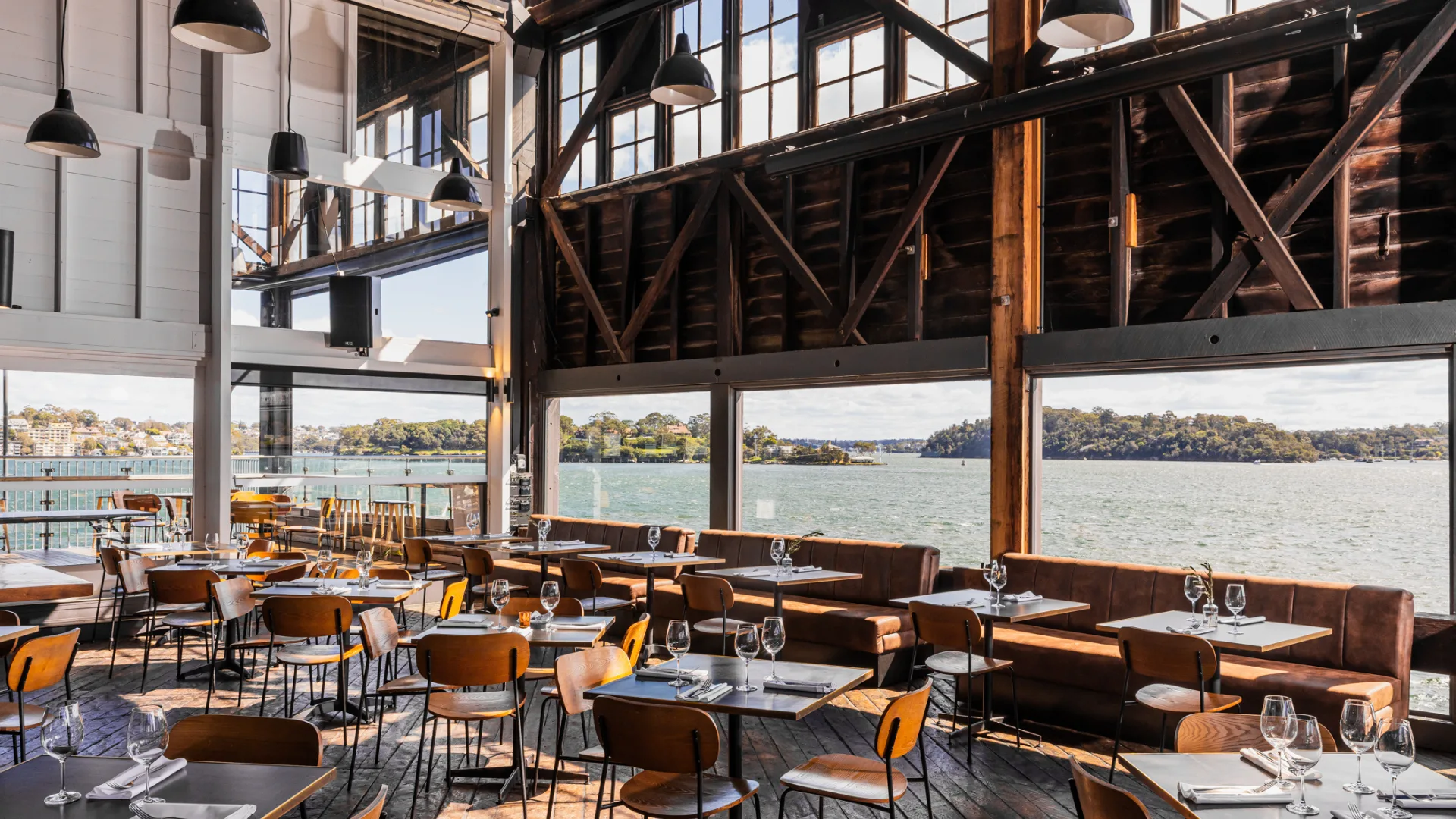 The dining room at The Wharf Bar & Restaurant, surrounded by water views