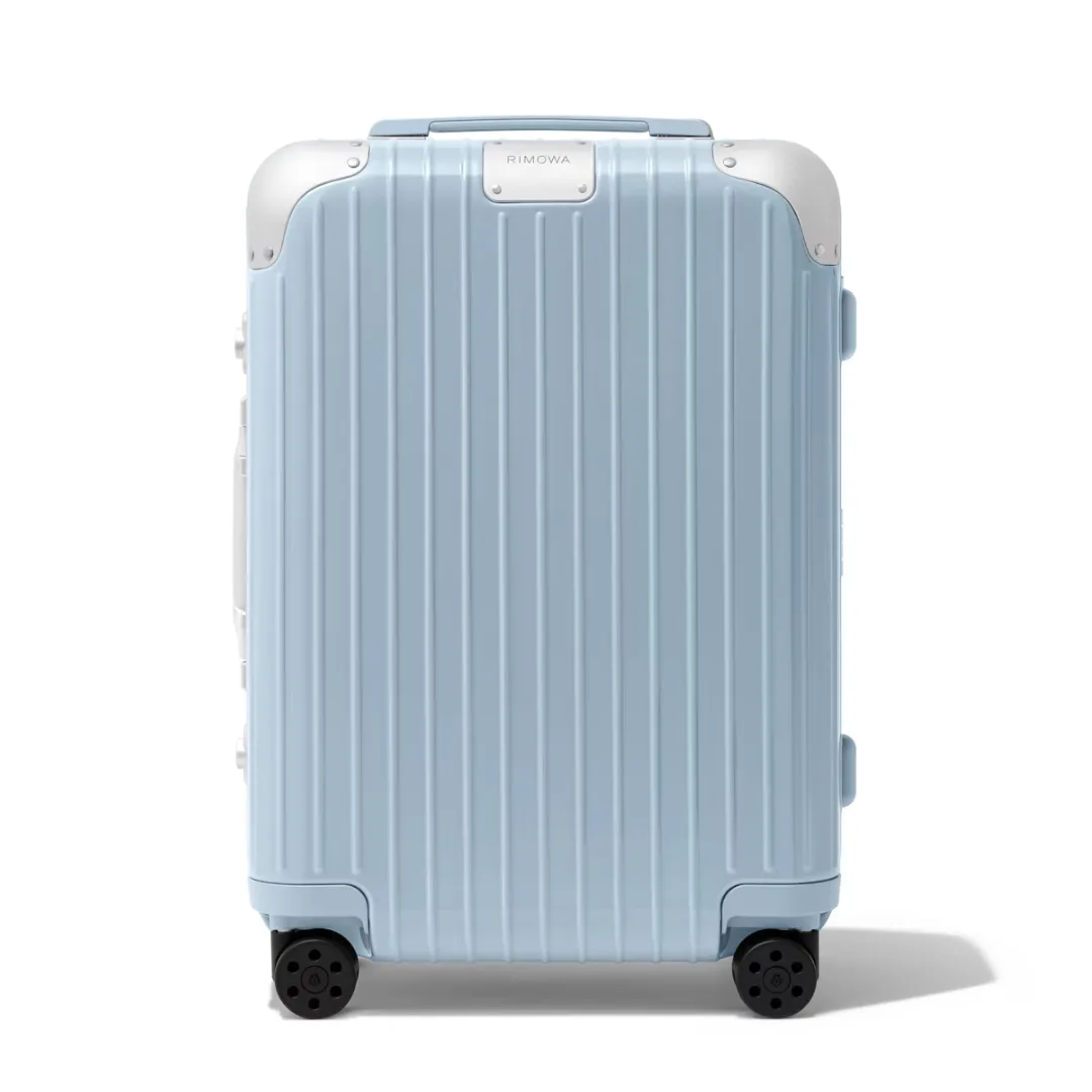 Rimowa hybrid cabin luggage in gloss sky blue, featuring lightweight polycarbonate shell and anodised aluminium corners and framing.