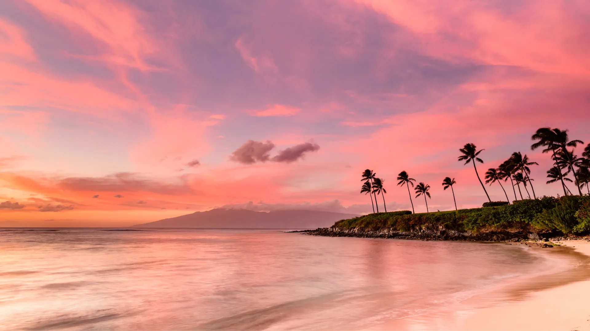 A pink sky above the lovely beach called Kapalua Bay, in Maui, Hawaii