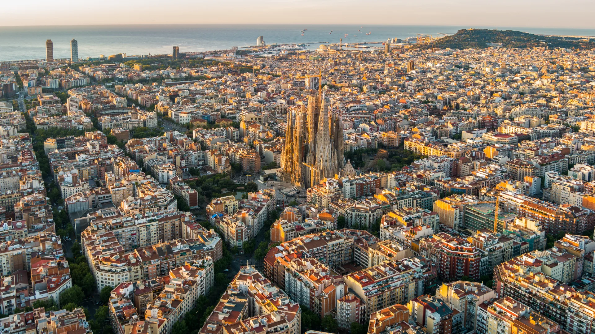 Sagrada Familia and Barcelona skyline at sunrise, aerial view. Catalonia, Spain, a popular destination to book during Black Friday flight sales