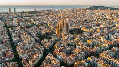 Sagrada Familia and Barcelona skyline at sunrise, aerial view. Catalonia, Spain, a popular destination to book during Black Friday flight sales