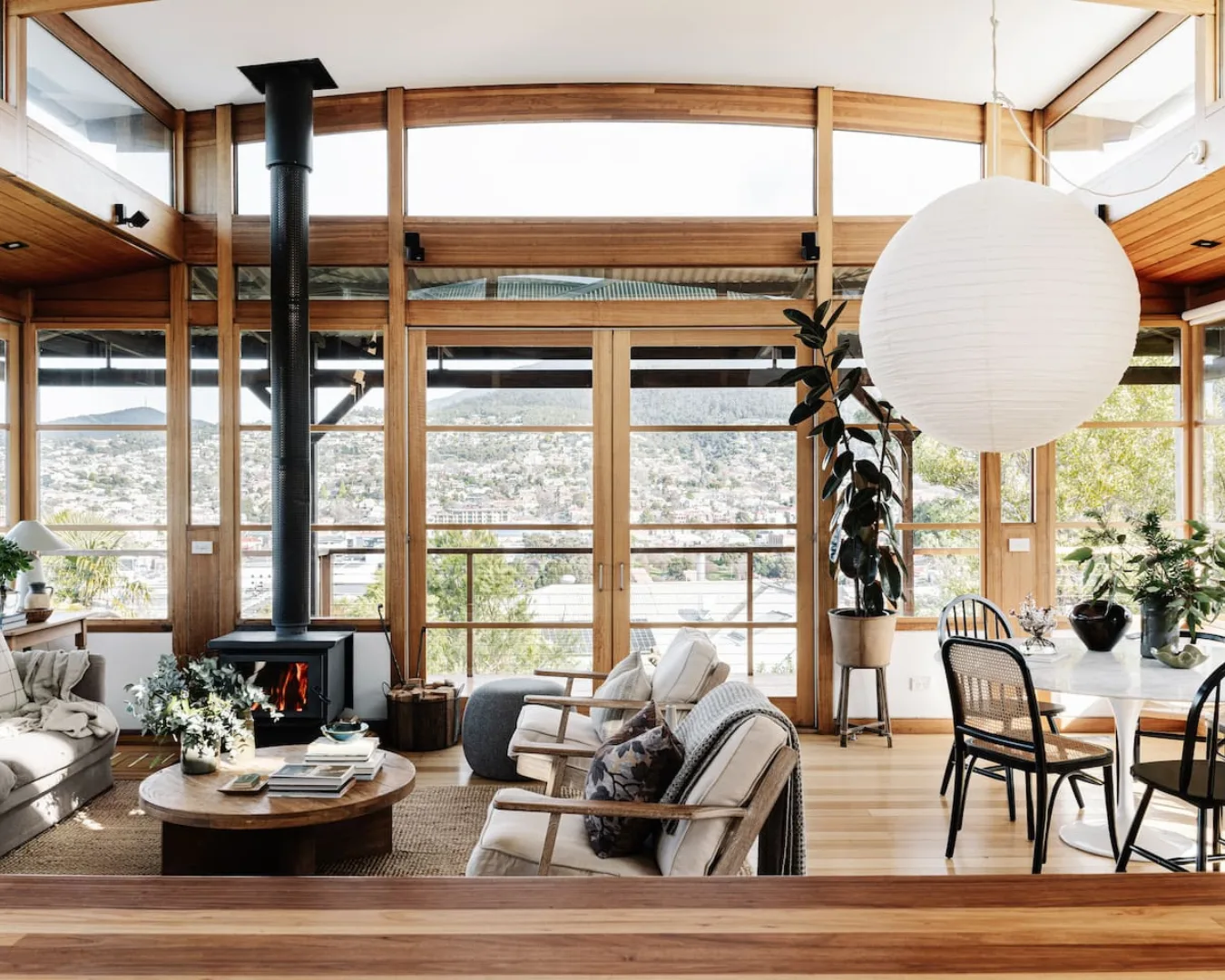 The cosy living room with a fireplace and beautiful view at top Hobart Airbnb Seaview