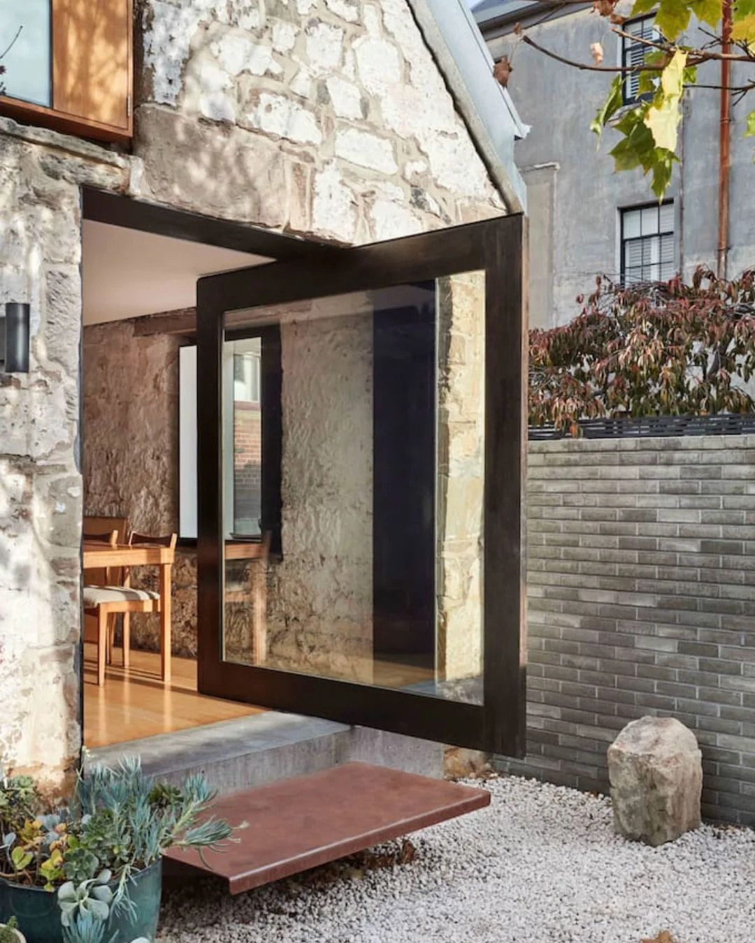 The pivot door of Hobart Airbnb The Barn, leading in to the converted accommodation.