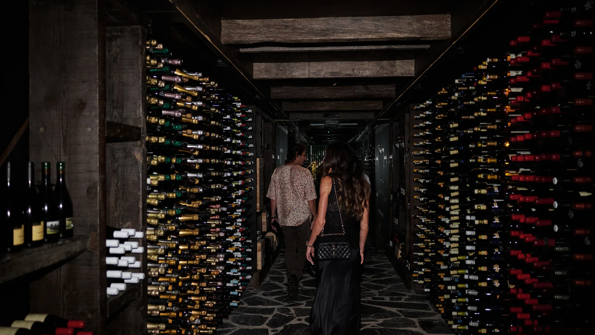 The wine bottle-lined entrance to Feu at The Belongil in Byron Bay