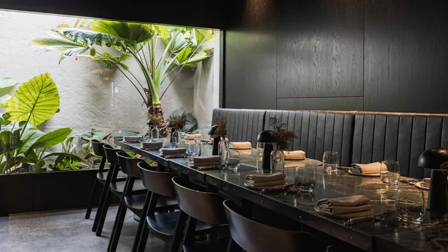 Essa's dining room; dark and moody with green marbled table top.