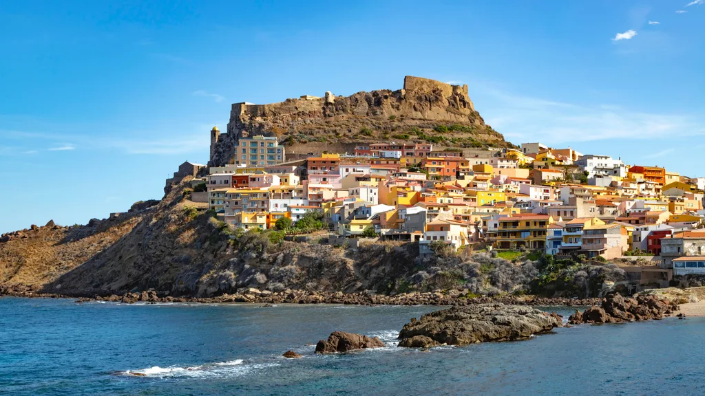 view of the town of Castelsardo with its colorful Mediterranean architecture and imposing fortress in Sassari, Sardinia, Italy