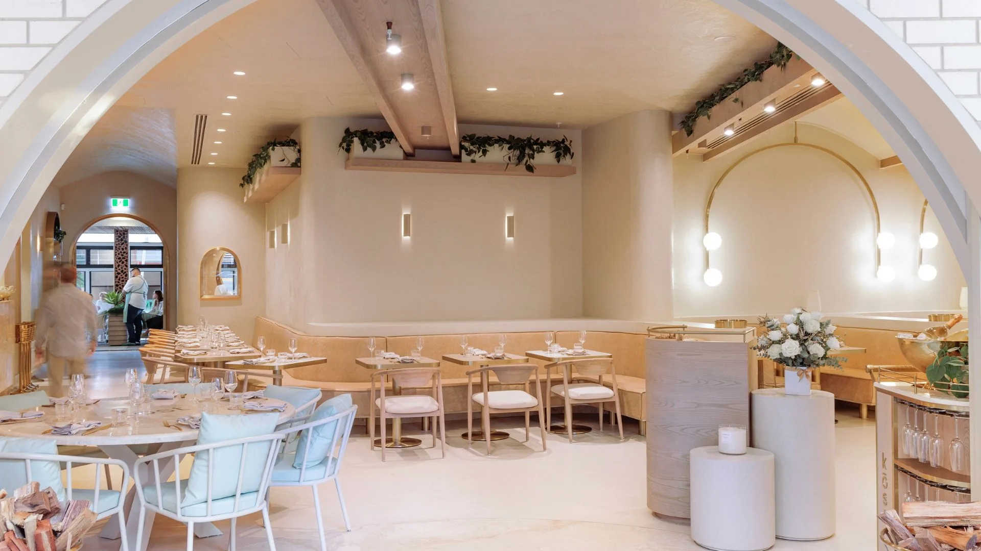 The dining area with light timber tables and chairs of Kost restaurant on the Gold Coast