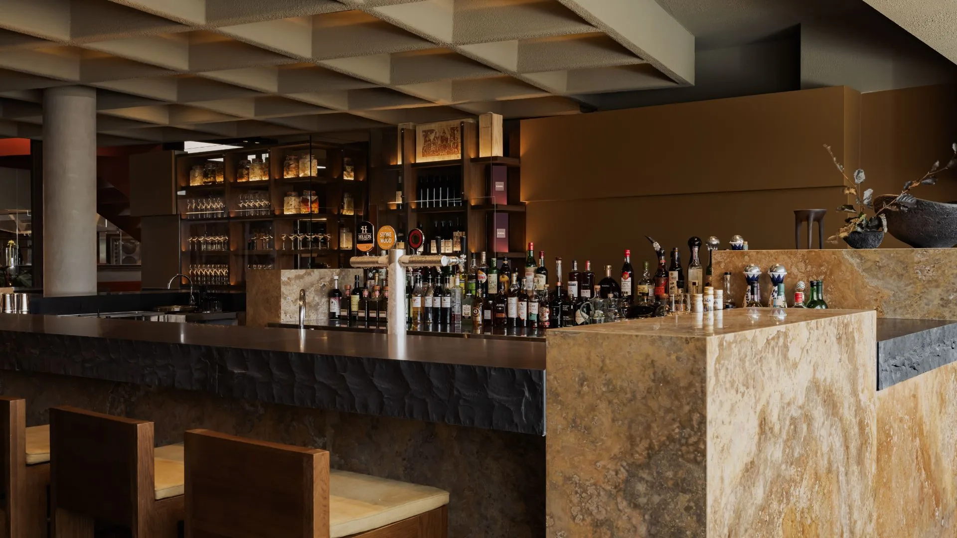 The brown marble bar and stone honeycomb ceiling at Norte on the Gold Coast