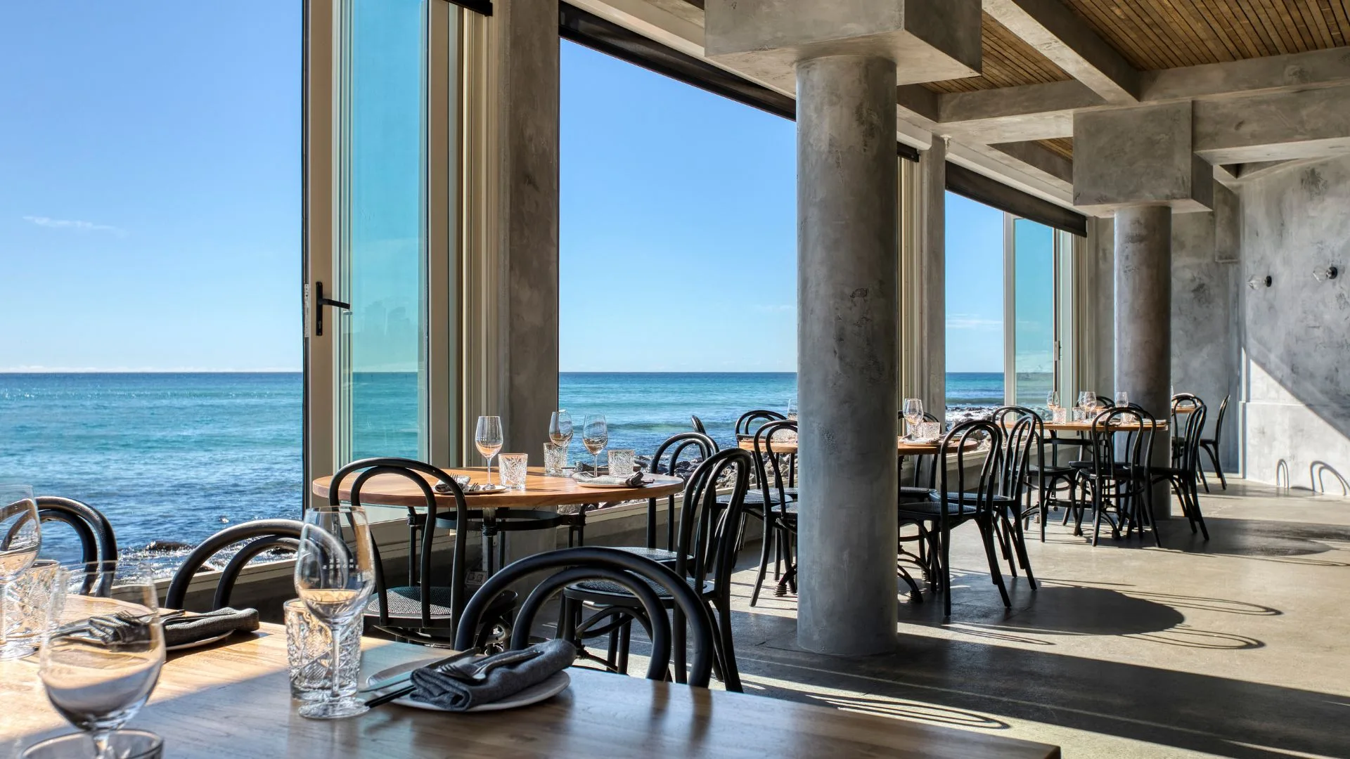 The dining room and floor to ceiling windows with ocean views from Rick Shores restaurant on the Gold Coast
