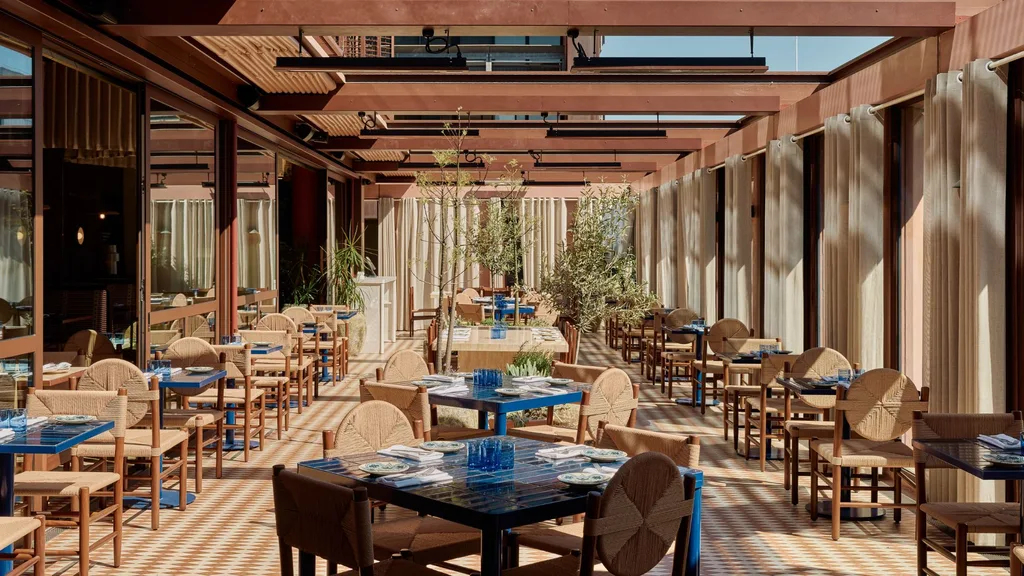 The Cleo rooftop bar with blue tables and timber rafters in Melbourne CBD