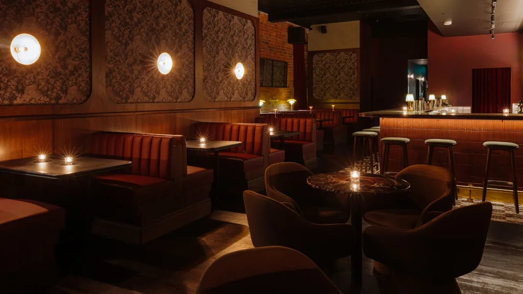 Red leather banquettes and tables at Death & Co's new bar in Melbourne
