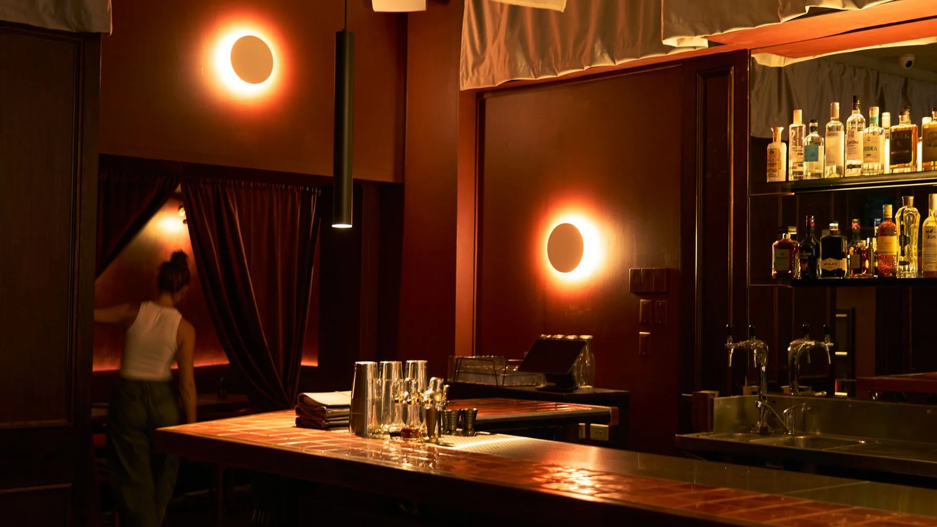 Two circular red lights like eclipse moons at Moondrop bar in Melbourne