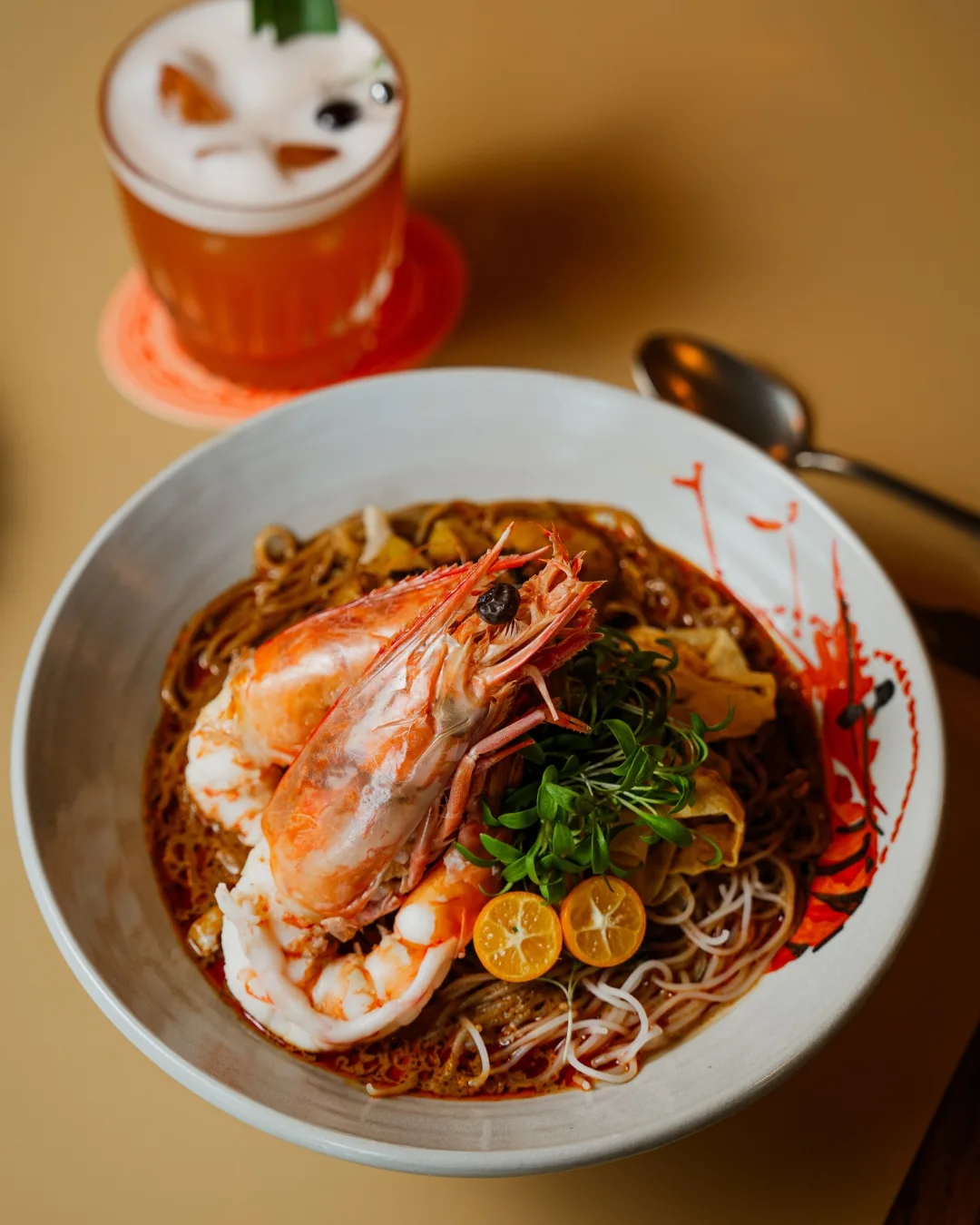 The Sarawak laksa featuring silky rice vermicelli noodles in a fragrant coconut broth infused with lemongrass, galangal, turmeric and chilli, that's then topped with poached chicken, king prawns and crisp bean sprouts.