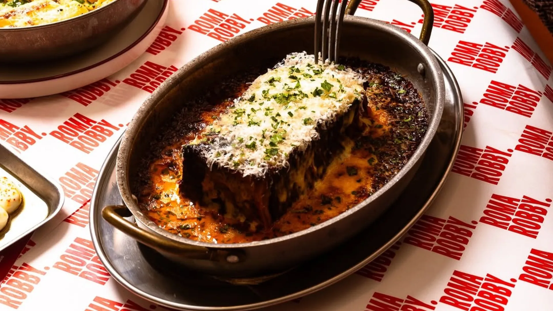 A 50-layer lasagne swimming in cheese and tomato at Roma Robby, Perth