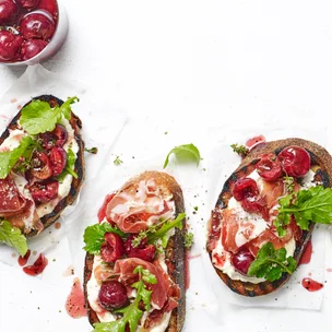 Easy, pickled cherry bruschetta with whipped feta and jamon