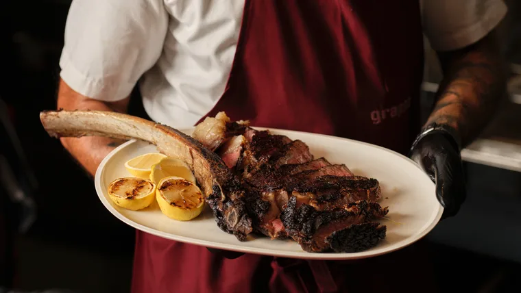 A grilled tomahawk steak at new Sydney restaurant Grappa The Rocks
