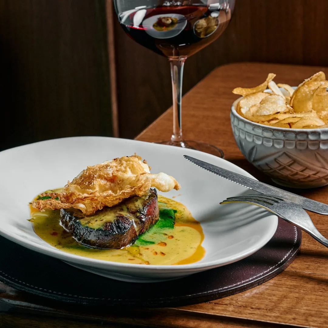 Marmelo's lunch special of eye fillet topped with whipped anchovy butter, fried hen's egg and potato crisps.
