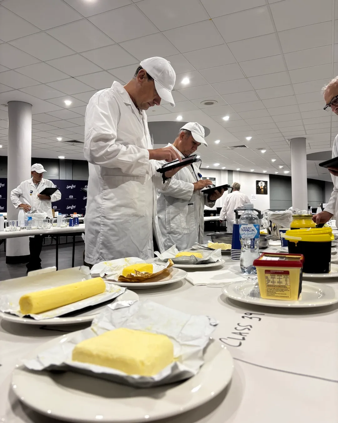 Judges examining butter for the Sydney Royal Cheese & Dairy Produce Show