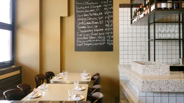 Black and white chalkboards denote Caness' wine list