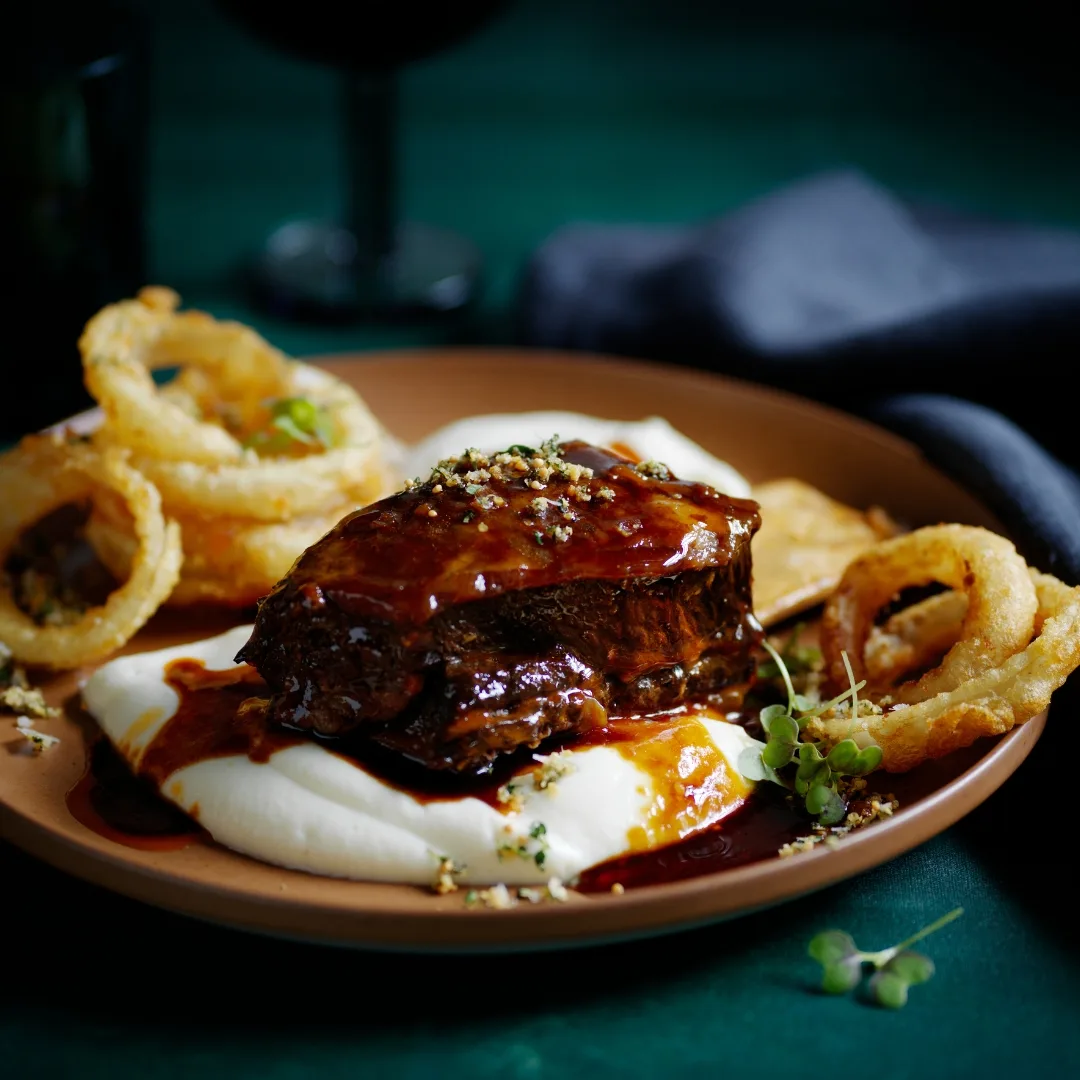 Pilsener-braised beef short ribs with mash and onion rings recipe ...