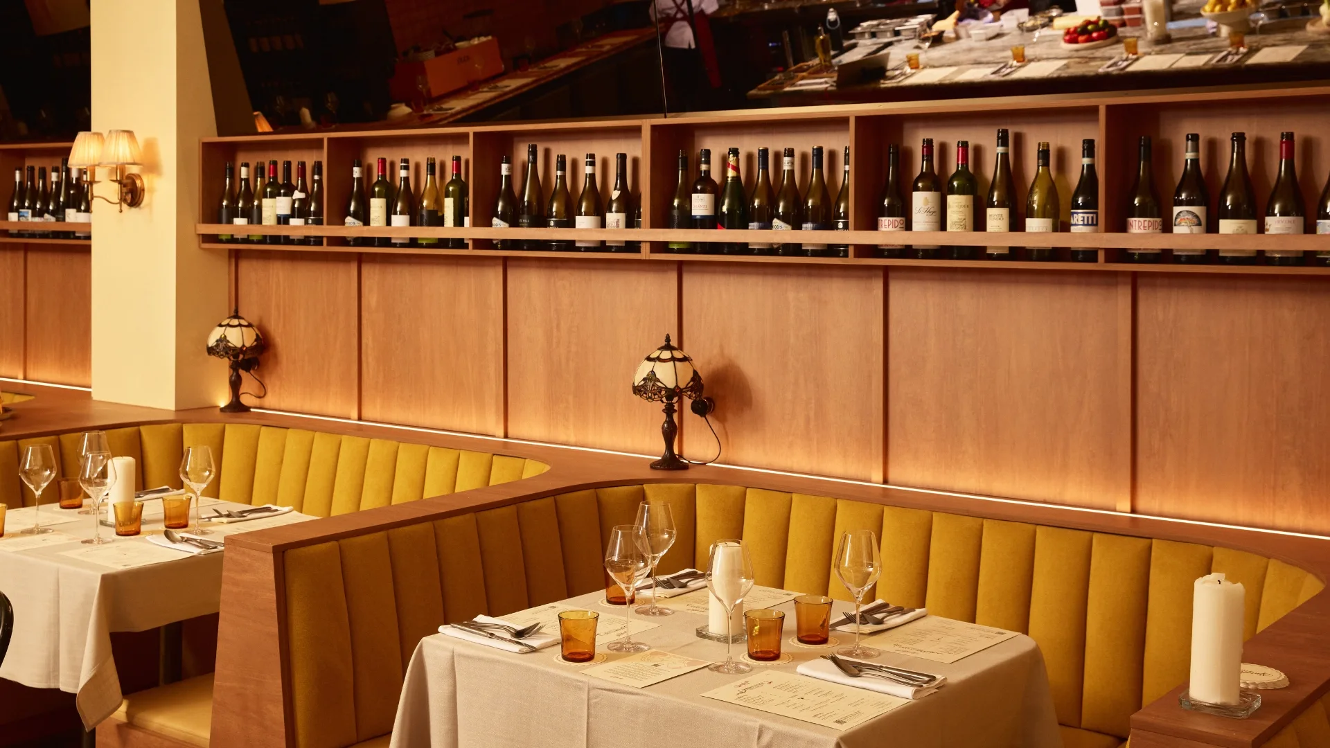 Sunshine-yellow booths, vintage lights and dark timber panelling set the scene at Richmond's Spaghetti Club