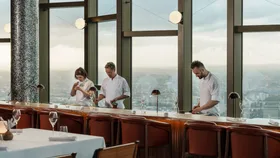 Chefs at work at Table Nineteen at Melbourne restaurant Atria, set against a backdrop of Melbourne views