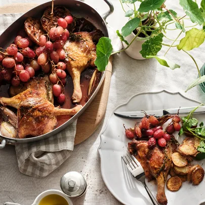 Braised duck with grapes, duck-fat potatoes and watercress