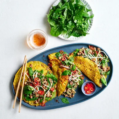 Báhn xèo with pork larb and herbs