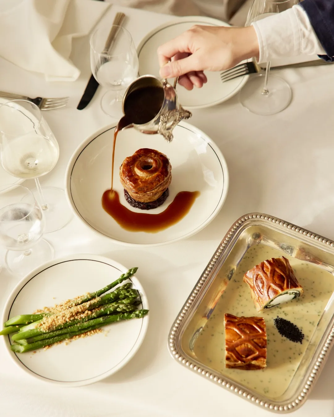 Coral trout wellington, asparagus and another Marlowe pastry are served on beautiful dishware 