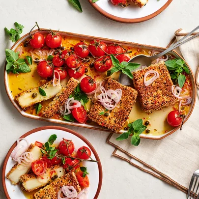 Sesame and nigella seed crusted haloumi with roast tomatoes