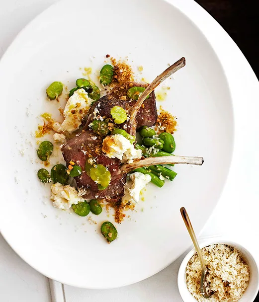 Roast lamb rack with spring onions, broad beans and goat’s cheese