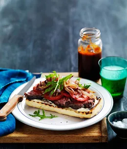 Open steak sandwich with onions and barbecue sauce