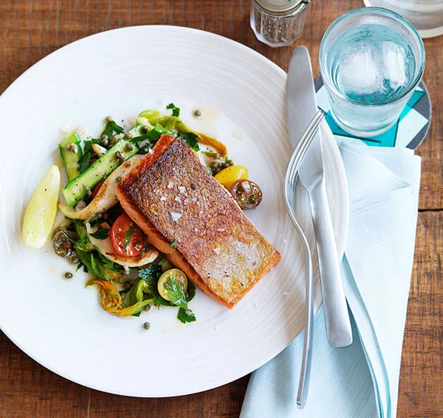 Ocean trout with calamari, cherry tomato and zucchini flower salad