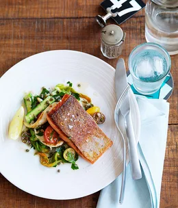 Ocean trout with calamari, cherry tomato and zucchini flower salad