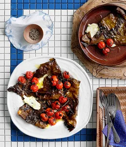 Kefalograviera baked in vine leaves with cherry tomatoes