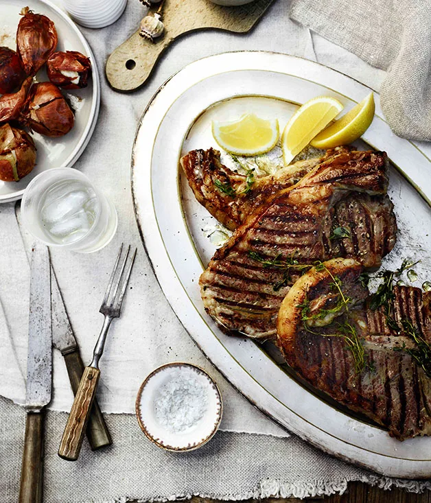 Barbecued T-bones with herb oil and Taleggio onions