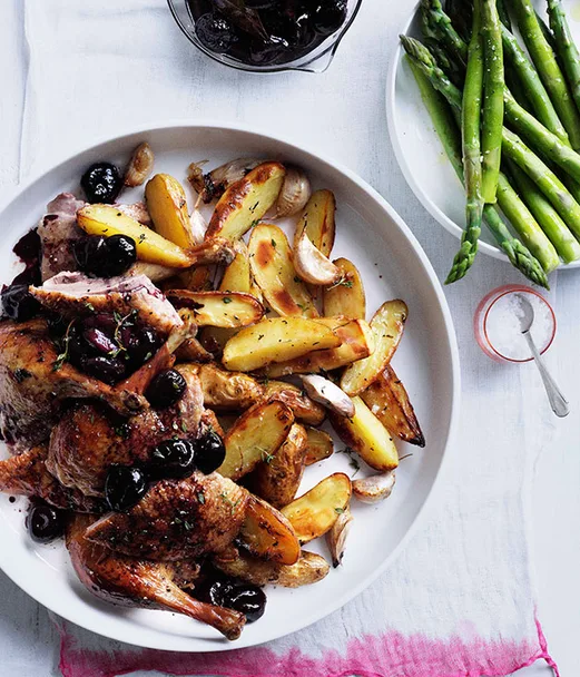 Roast duck with cherries and roast kipfler potatoes
