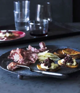 White bean and olive crostini with salami and Pecorino Sardo