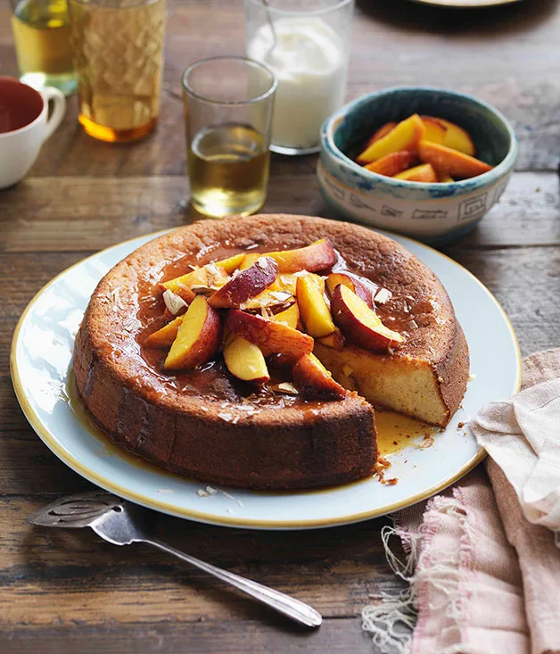 Yoghurt and almond cake with orange-caramel peaches and vanilla yoghurt