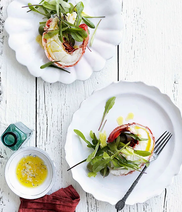 Lobster halves with lemon butter and dandelion leaf salad