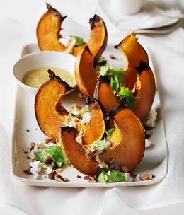 Roast pumpkin wedges with almonds, goat’s cheese and tahini dressing