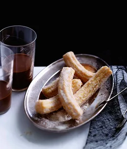 Orange-scented churros with spiked hot chocolate